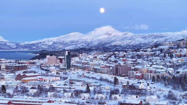 Panoramic aerial view of Narvik, Norway, snow capped mountains, picturesque winter wonderland village