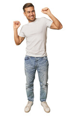 Fototapeta premium Full body portrait of a man in studio celebrating a special day, jumps and raise arms with energy.
