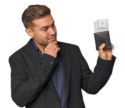 business caucasian man holding tickets looking sideways with doubtful and skeptical expression. - Powered by Adobe