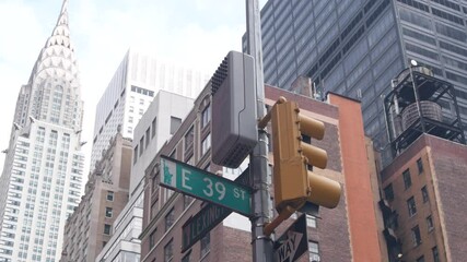 New York City crossroad, Lexington street intersection road sign post. Chrysler building, Midtown district, NYC, United States. Highrise skyscraper architecture, corner one way roadsign, traffic light