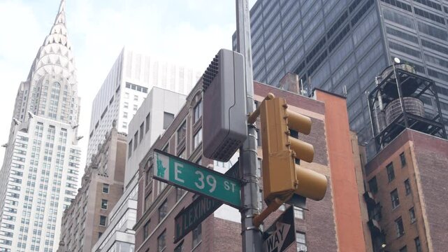 New York City crossroad, Lexington street intersection road sign post. Chrysler building, Midtown district, NYC, United States. Highrise skyscraper architecture, corner one way roadsign, traffic light