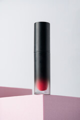 Mockup of black blank thin tube - mascara, lip gloss, gel, eyeliner, oil, etc. Cosmetic package with stylish props on white background. 
