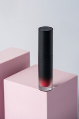 Obraz premium Mockup of black blank thin tube - mascara, lip gloss, gel, eyeliner, oil, etc. Cosmetic package with stylish props on white background. 