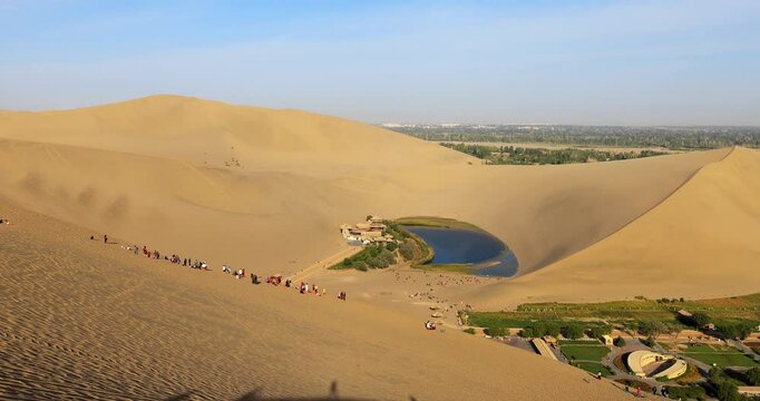 Dunhuang Crescent Spring and Singing Sand Mountain.It is located in the ring of the sand Mountain, because the shape of a curved crescent moon named. It is the first spring in the desert.