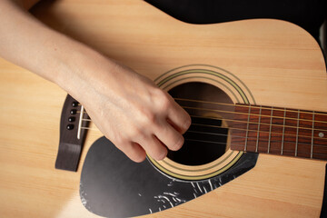 Hand Playing Acoustic Guitar Close-Up, studying musical instrument, education learning practice
