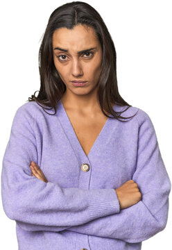 Hispanic young woman unhappy looking in camera with sarcastic expression.