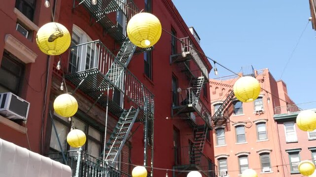 New York City, United States. Manhattan Chinatown Doyers street, chinese ethnic district building architecture, USA. Brick houses, round paper lanterns, little China town. American fire escape ladder.