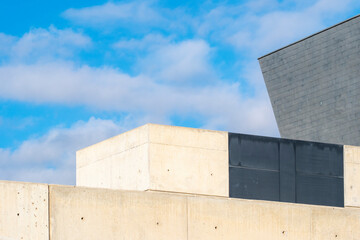 A minimalistic image showcasing abstract shapes rising against a cloudy sky, evoking feelings of tranquility and contemplation through simplicity and contrast in form.