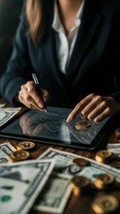 A business professional is analyzing cryptocurrency trends on a tablet, surrounded by cash and gold coins.
