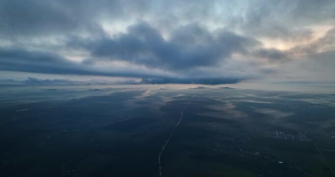 Beautiful sunrise sky above clouds with dramatic light. View from drone