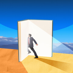 Businessman walking into glowing light of open book in desert, symbolizing transformative power of...