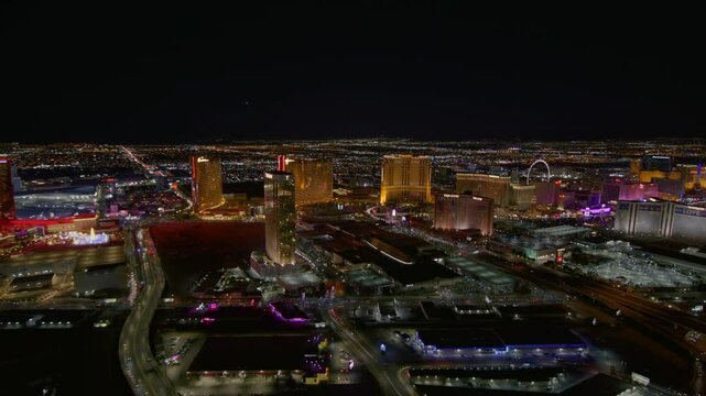 Aerial Panning Shot Of Illuminated Modern Landscape Of City Against Dark Clear Sky At Night - Las Vegas, Nevada
