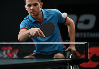 Young Caucasian male in wheelchair playing table tennis