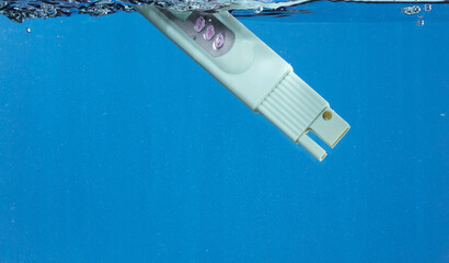 PH acid level test Device tools on quality water on screen. PH acid level tester device tools fall...