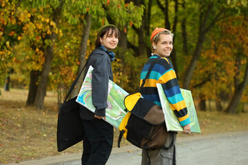 two young and innovative female artists conducting an outdoor painting lesson. Surrounded by...