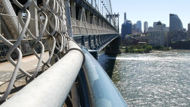 New York City Manhattan Bridge to Dumbo, Brooklyn. Waterfront skyline cityscape from pedestrian path. East river water. Riverfront architecture.