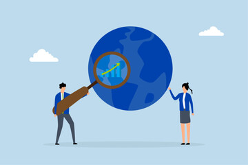World economic analysis, entrepreneur using magnifying glass on globe alongside chart and graph. 