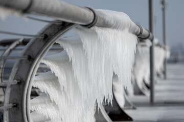 Ice on the railing at the seaside in cold weather