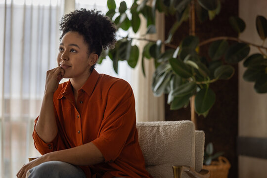 African American woman sitting at home thinking of her future