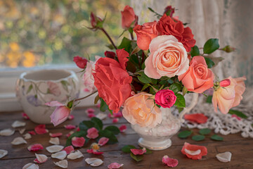 Roses in a vase on a wooden table