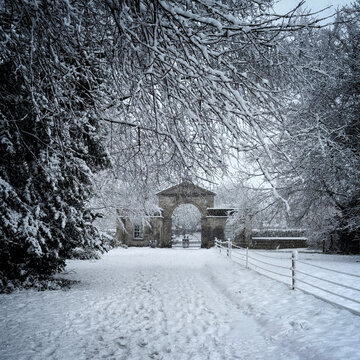 arched entrance to country estate in the snow