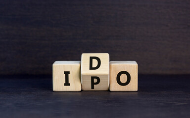 Initial public or DEX offering symbol. Concept words abbreviation IPO or IDO on wooden block....