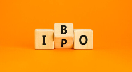 Initial public or bond offering symbol. Concept words abbreviation IPO or IBO on wooden block....