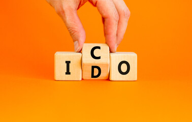 Initial coin or DEX offering symbol. Concept words abbreviation ICO or IDO on wooden block....