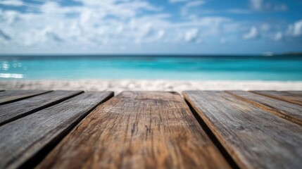 Fototapeta premium Wooden Table in Focus with Blurred Summer Beach and Tranquil Ocean View in Background