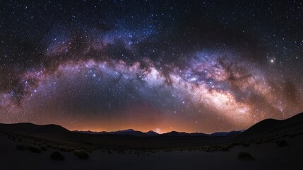 Naklejka premium Majestic Milky Way galaxy arching over a serene landscape illuminated by minimal light pollution in a remote, starry night setting.