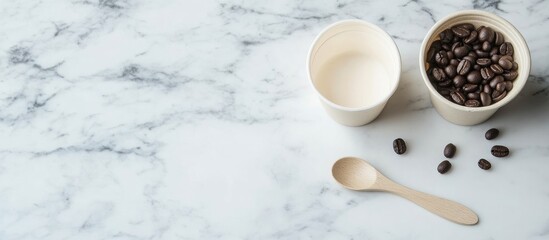 Biodegradable cup with coffee beans and spoon on marble surface promoting zero waste lifestyle and eco-friendly concepts for advertising