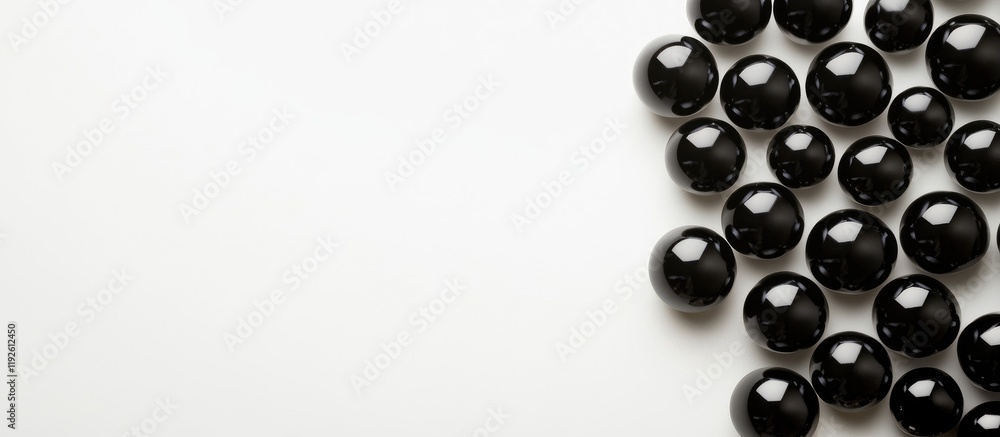Aufkleber elegant black smooth beads arranged on a white background with ample blank space for customizable te