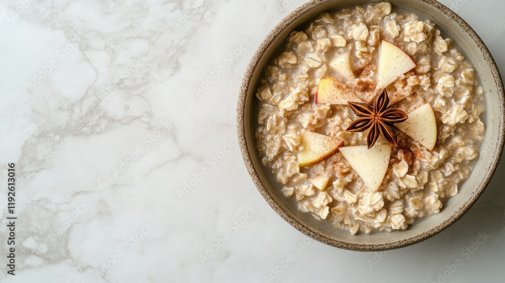 Poster healthy breakfast bowl of oatmeal topped with apples cinnamon and star anise on marble surface with 