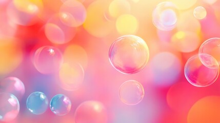Colorful bokeh background with delicate bubbles creating a dreamy atmospheric effect in warm orange and pink hues