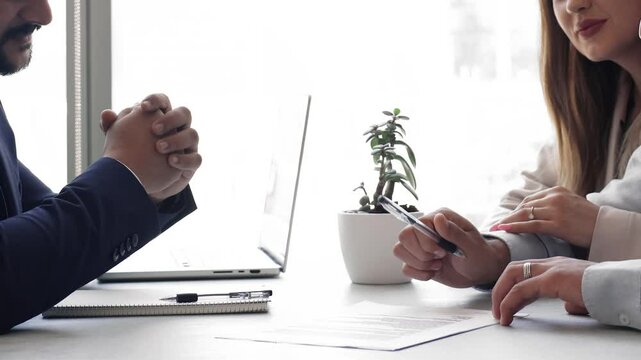 Couple signing contract, shaking hands advisor or company manager, feel satisfied with services, bought house, getting mortgage, finalize meeting in bank office, close-up view. Making commercial deal