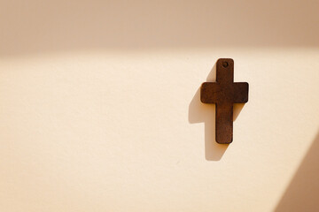 holy bible and cross on the table on pastel background.