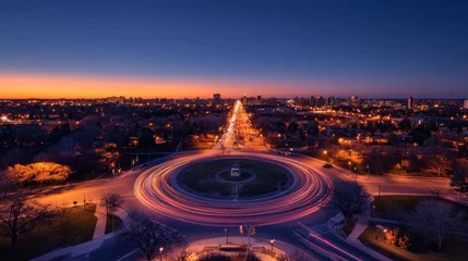 Papier peint photo  Night cityscape with roundabout and light trails at sunset.  © huhu
