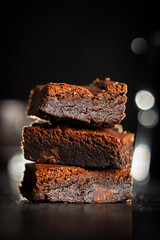 Homemade chocolate brownies on black table.