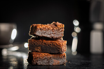 Homemade chocolate brownies on black table.