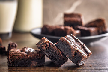 Homemade chocolate brownies on wooden table.