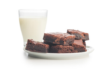 Homemade chocolate brownies and milk in glass isolated on white background.