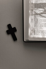 holy bible and cross on the table on pastel background.