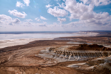 On the Ustyurt Plateau. Here, the Ustyurt Cliff steeply breaks by a cascade of clay-limestone and chalk steps, at the bottom of which lies a vast salt marsh, called in this region, Tuzbair.