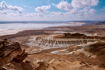 On the Ustyurt Plateau. Here, the Ustyurt Cliff steeply breaks by a cascade of clay-limestone and chalk steps, at the bottom of which lies a vast salt marsh, called in this region, Tuzbair.