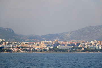 Fototapeta premium Contemporary buildings, gardens and beaches at the waterfront in Split, Croatia. View of Split from the boat.