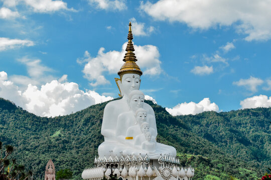 Majestic Five White Buddhas Statue Amidst Verdant Mountains at Wat Pha Sorn Kaew or Wat Phra Thart Pha Kaew Temple in Khao Kho, Phetchabun, Thailand