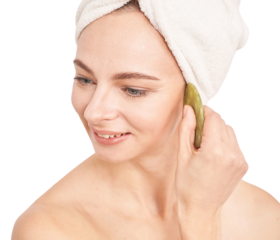 Caucasian female adult using natural jade stone for facial massage in skincare 