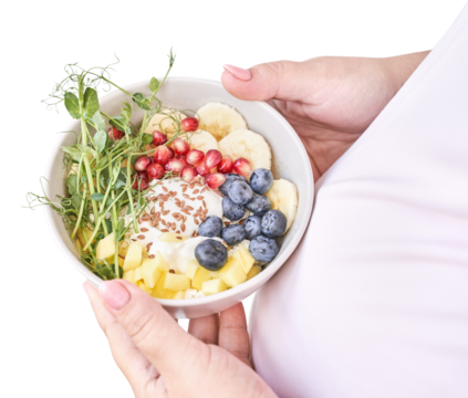 Female holding bowl with fresh fruits and yogurt including banana, pomegranate