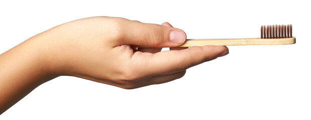 Hand holding eco friendly bamboo toothbrush for sustainable oral care