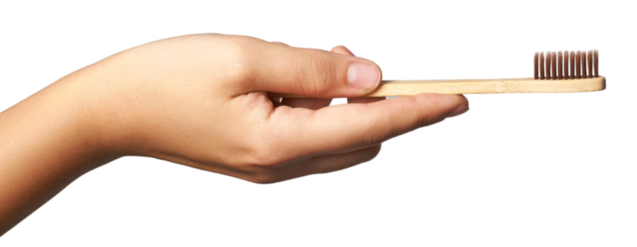 Hand holding eco friendly bamboo toothbrush for sustainable oral care